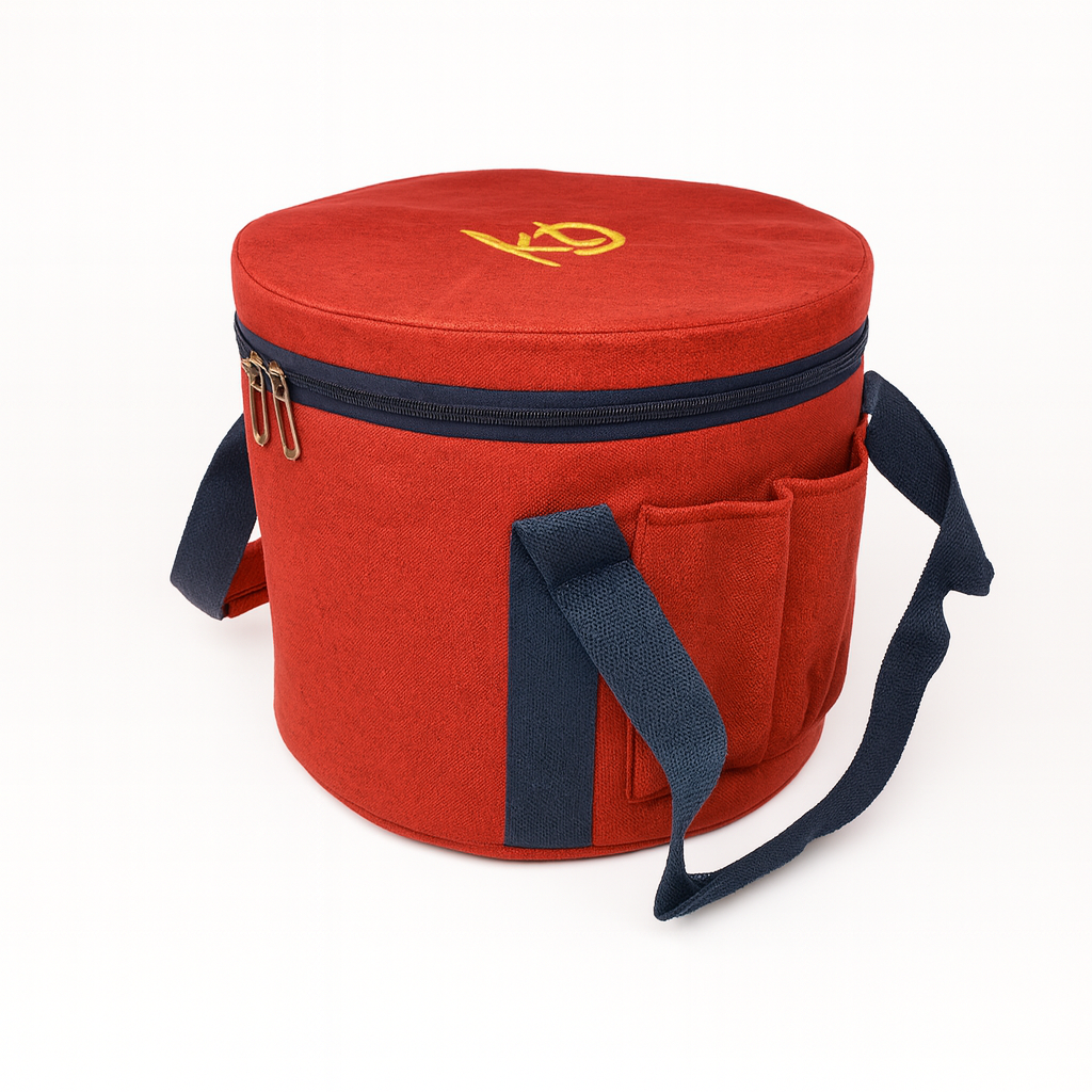 Red cylindrical cooler bag with navy accents and a yellow logo on a white background