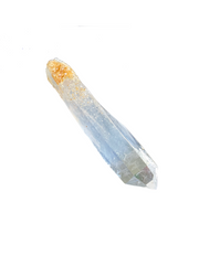 A Colombian clear crystal quartz point with a natural golden bottom against a white background - JOY - Journey Of You - Spiritual, Holistic, Empowering