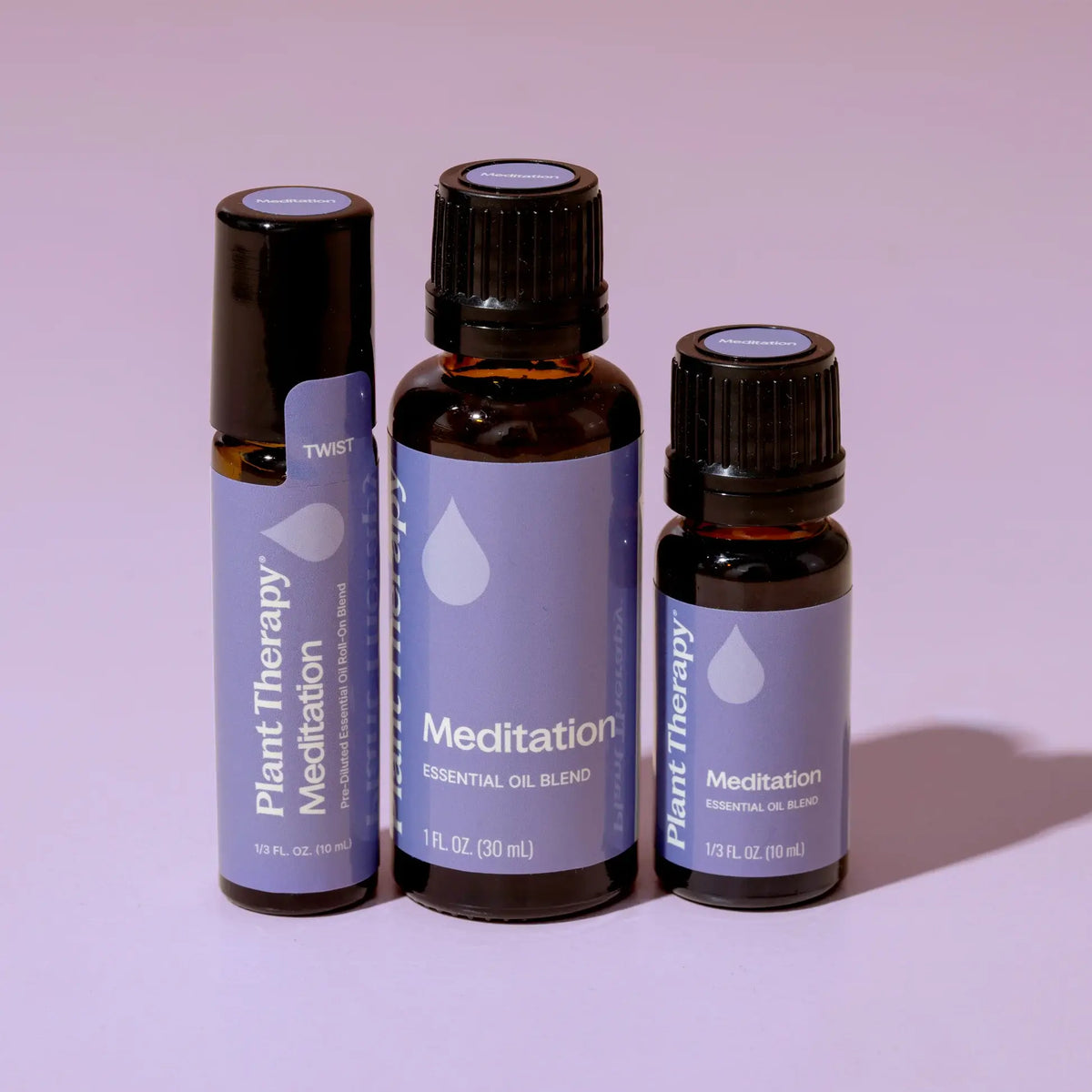 Three bottles of Plant Therapy Meditation essential oil blend on a light purple background - JOY - Journey Of You - Spiritual, Holistic, Empowering