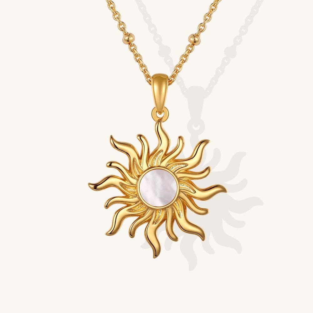 Gold sun-shaped pendant necklace on a white background