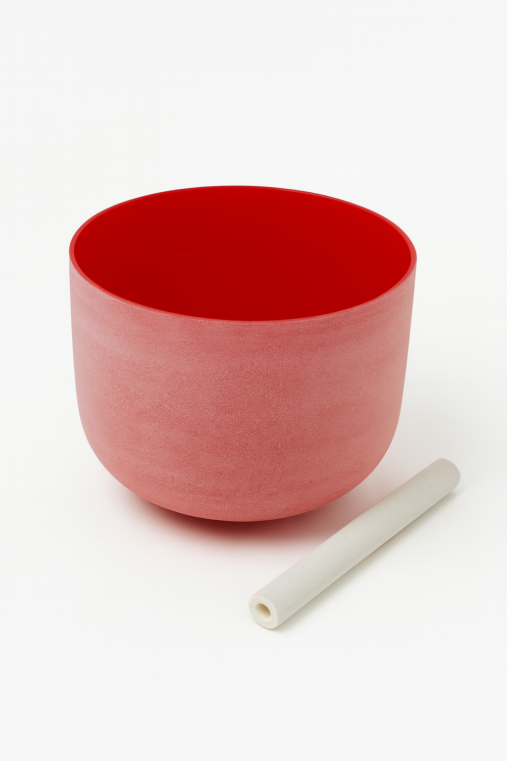 Red ceramic bowl with a white cylindrical object on a white background