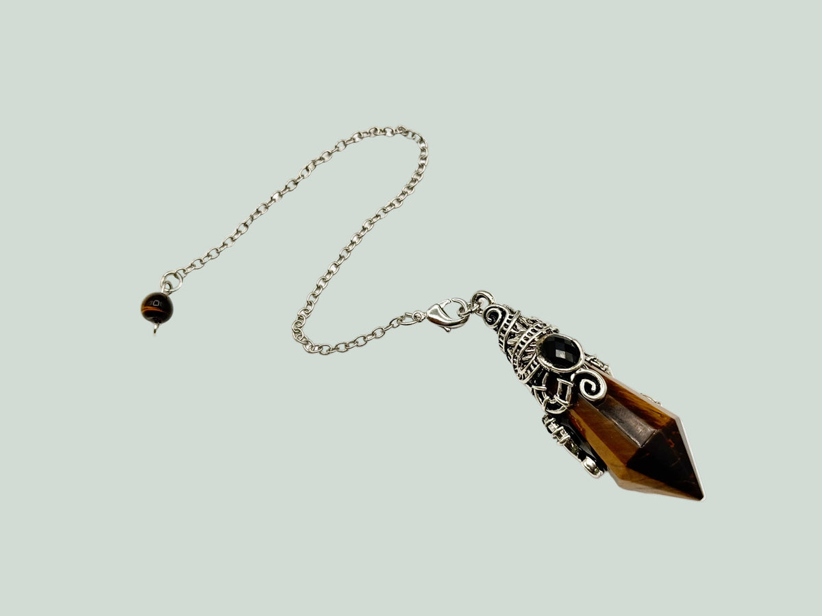 Necklace with a brown crystal pendant on a light gray background