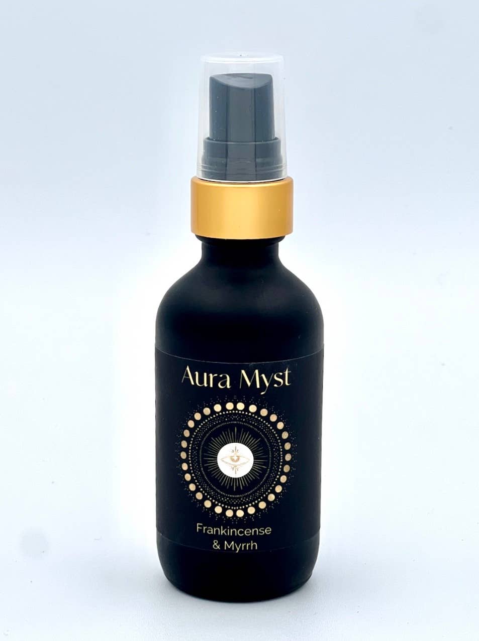 Aura Myst Frankincense & Myrrh bottle with gold cap on a light gray background