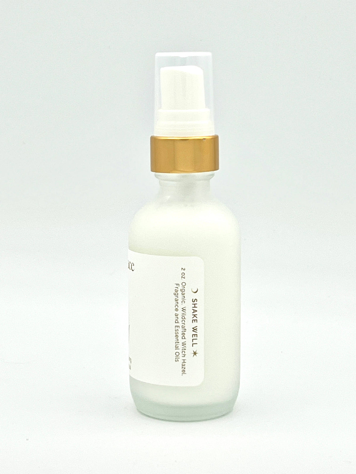 Skincare serum bottle with gold cap on a light gray background