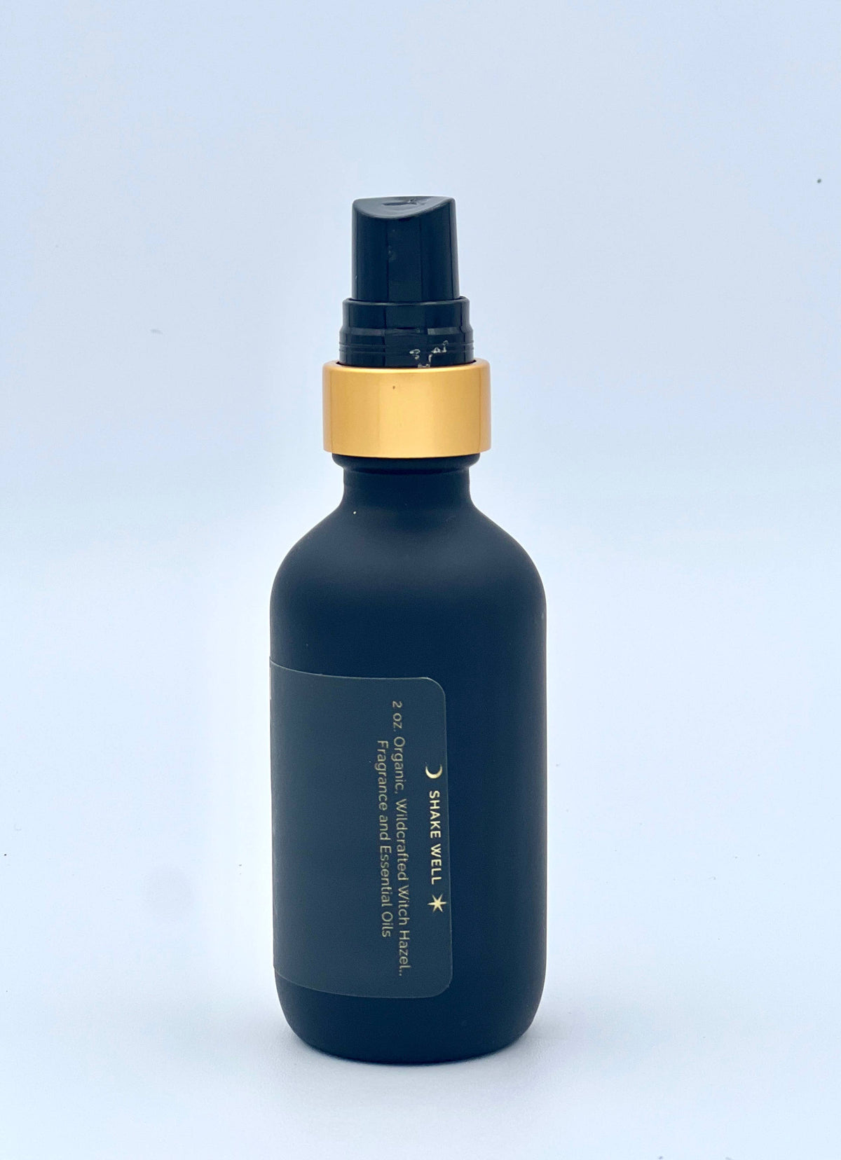 Dark blue bottle with gold cap on a light blue background