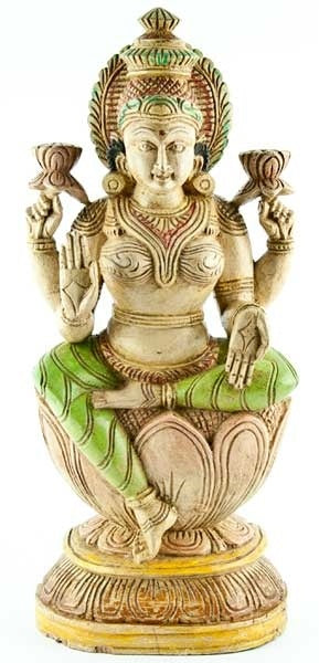 A wooden statue of the Hindu goddess Laxmi, seated and holding a lotus flower, with intricate details and a green and gold finish - JOY - Journey Of You - Spiritual, Holistic, Empowering