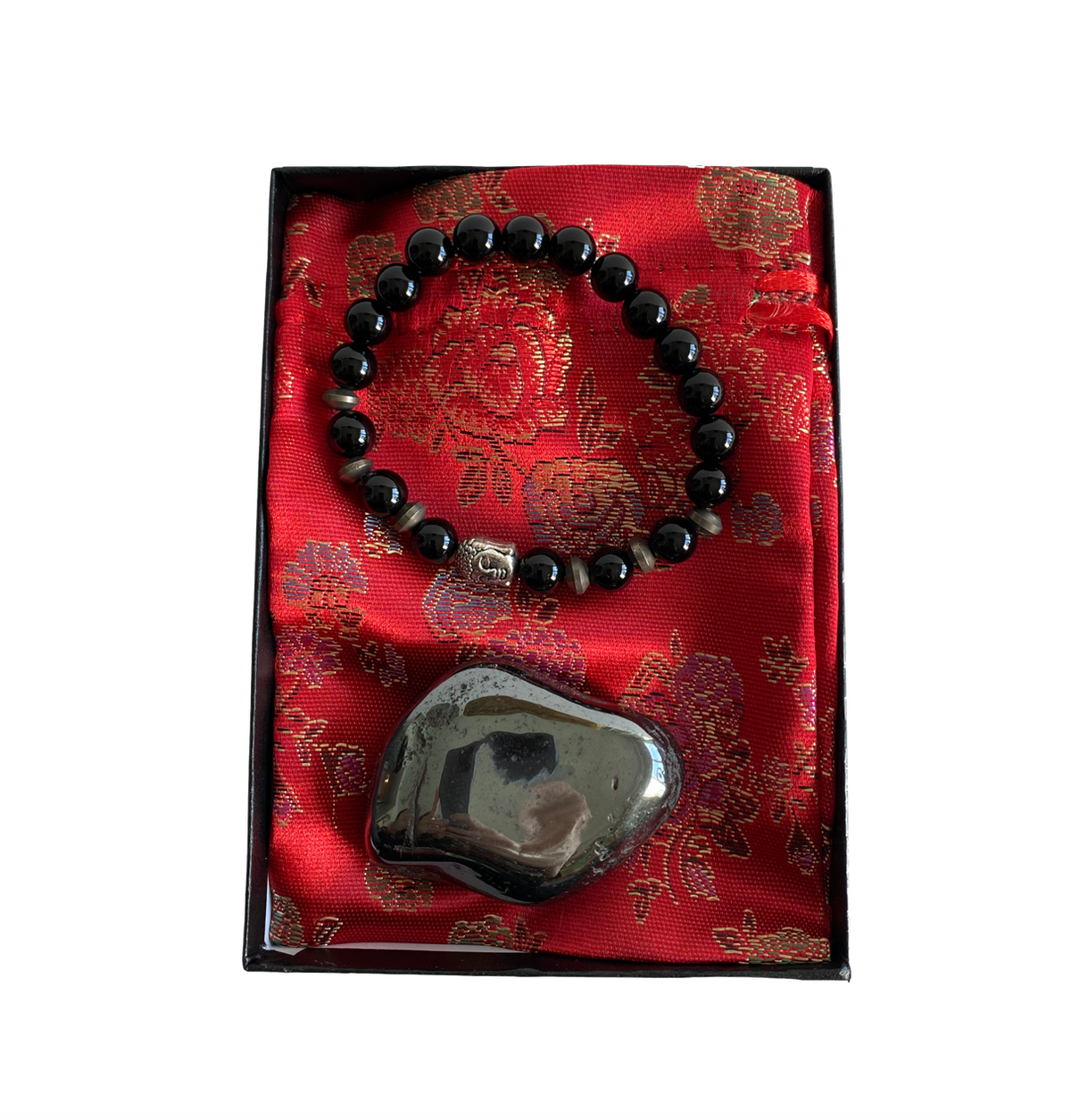 A gift box with a red carrier pouch, an Obsidian Buddha Bracelet, and a Hematite Stone displayed on top - JOY - Journey Of You - Spiritual, Holistic, Empowering