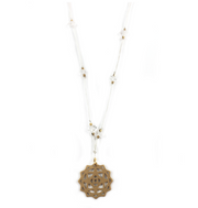 A delicate white chakra yoga necklace with brass charms and semi-precious stones, displayed on a plain background - JOY - Journey Of You - Spiritual, Holistic, Empowering