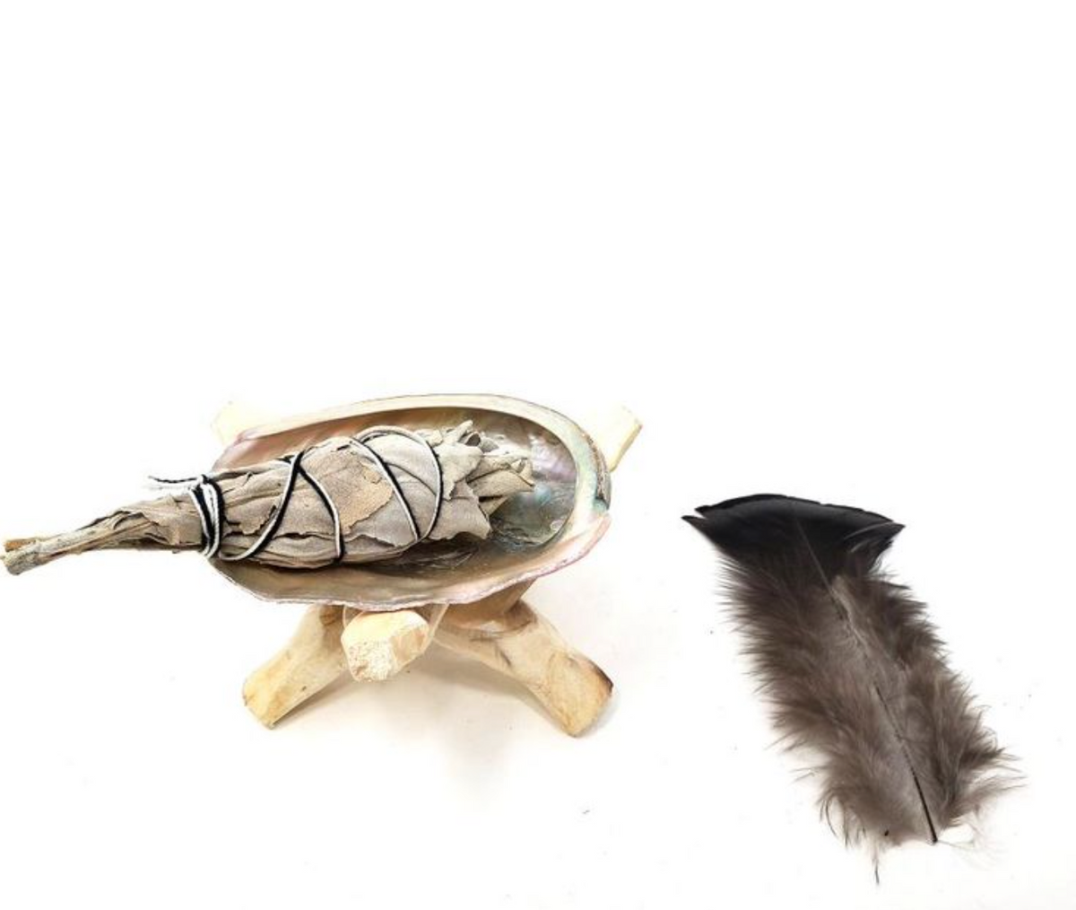 A travel-sized smudging kit including a bundle of white sage, a shell, a tripod, and a feather, arranged on a white background - JOY - Journey Of You - Spiritual, Holistic, Empowering
