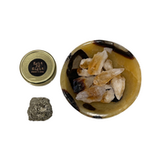 A bowl carved from Septarian stone, containing Citrine and Pyrite crystals, with a small Pyrite out of the bowl and a label that reads 'Reiki Room' - JOY - Journey Of You - Spiritual, Holistic, Empowering