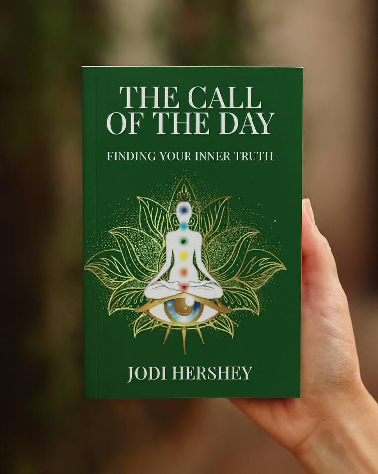 Book titled 'The Call of the Day: Finding Your Inner Truth' by Jodi Hershey held in a hand with a blurred natural background.