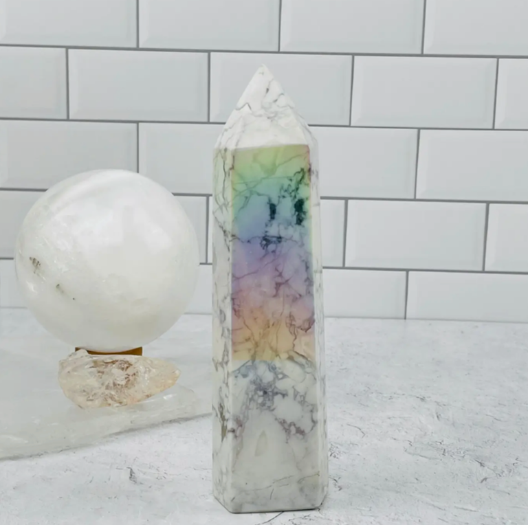 WHITE HOWLITE TOWER WITH ANGEL AURA FINISH - white stone with fine gray marbling and is very calming. It brings patience & soothes anger - “ATTUNEMENT STONE” - higher spiritual consciousness.
