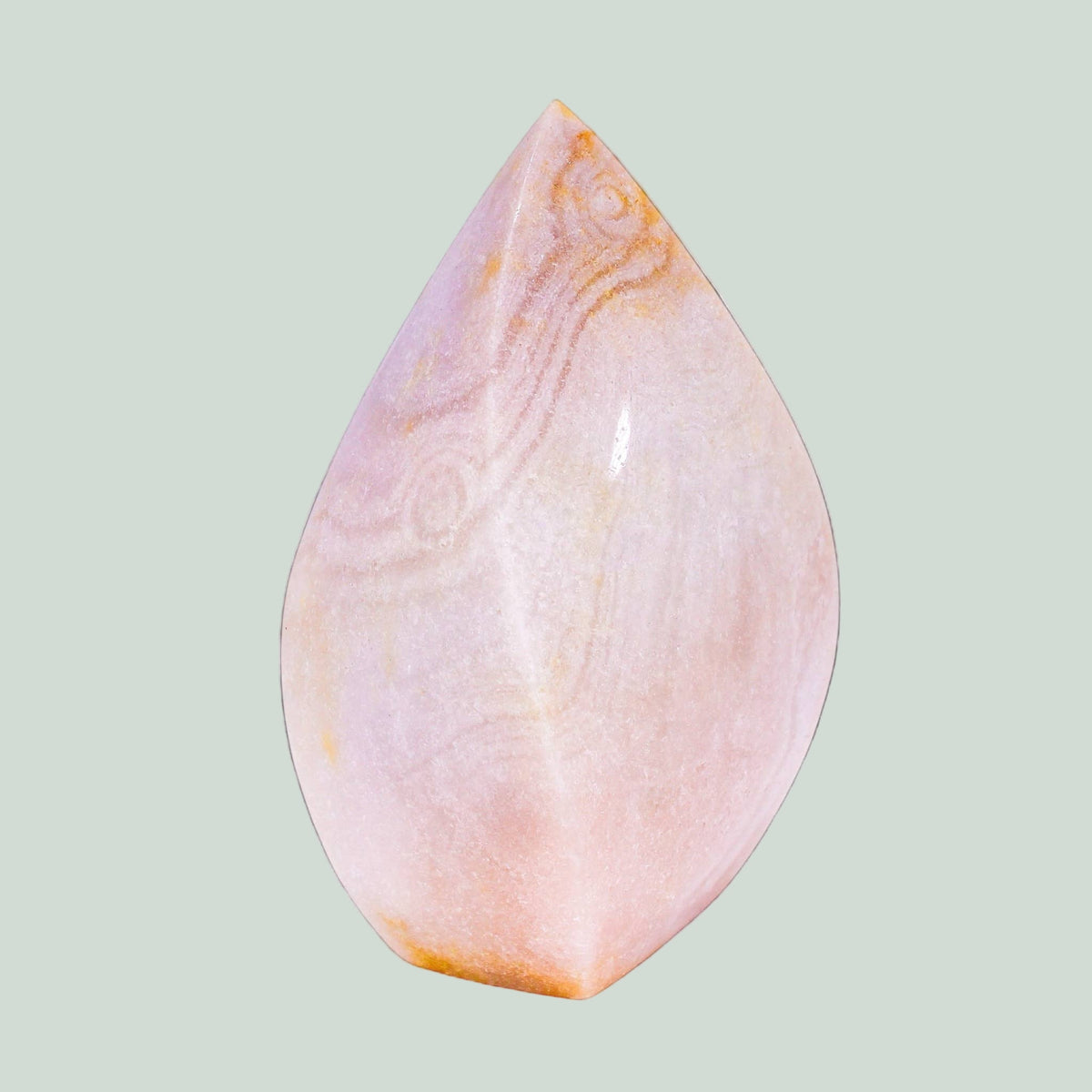 Teardrop-shaped pink stone with marbled pattern on a light green background
