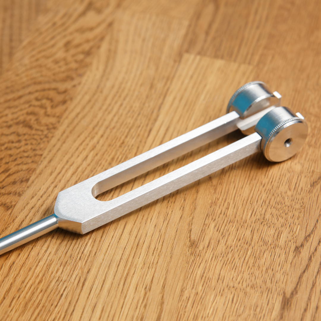 Metal tuning fork on a wooden surface