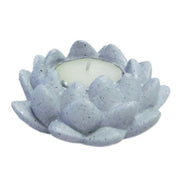 A gray concrete lotus-shaped candle holder with a lit candle inside - JOY - Journey Of You - Spiritual, Holistic, Empowering