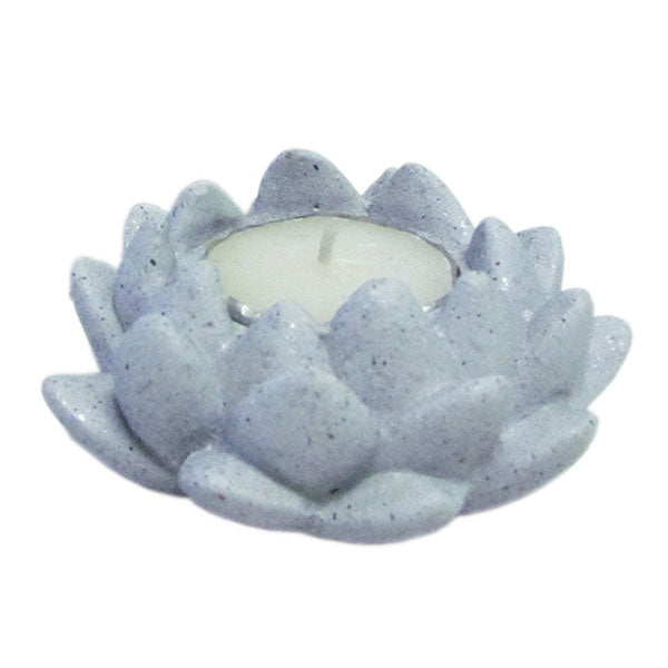 A gray concrete lotus-shaped candle holder with a lit candle inside - JOY - Journey Of You - Spiritual, Holistic, Empowering