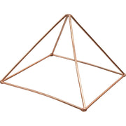 A copper pyramid energizer with a geometric shape designed for charging crystals or pendulums.